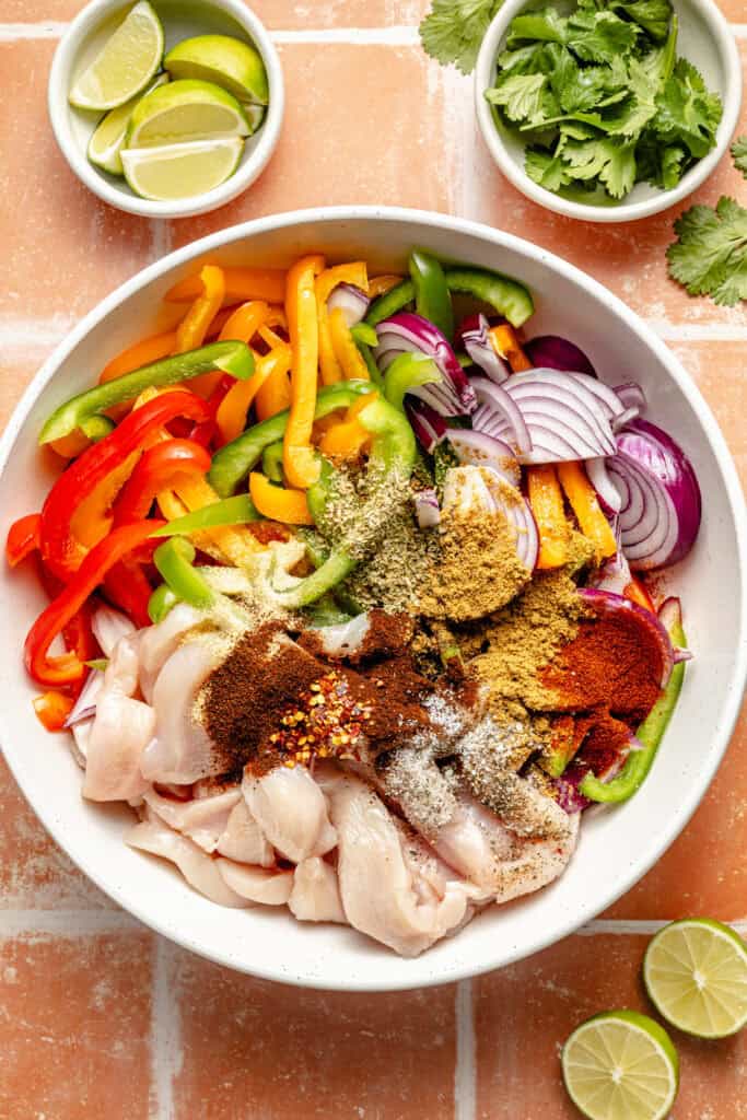 chicken, veggies, and spices in mixing bowl