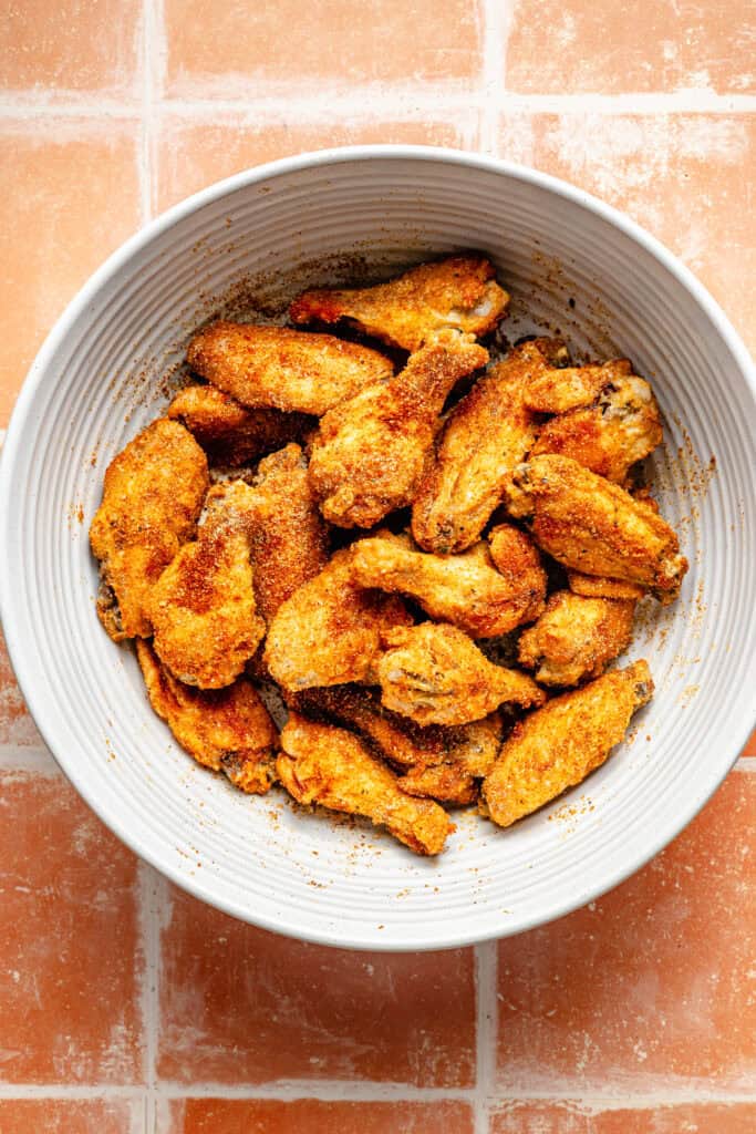 crispy wings in mixing bowl
