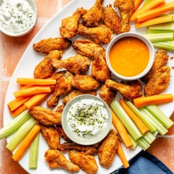 crispy baked chicken wings with dips and carrots and celery