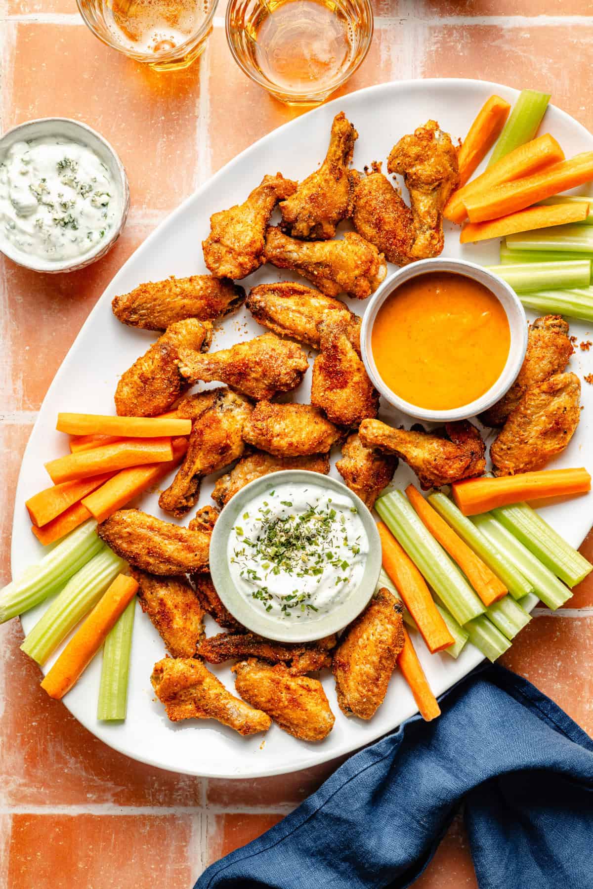 crispy baked chicken wings with dips and carrots and celery