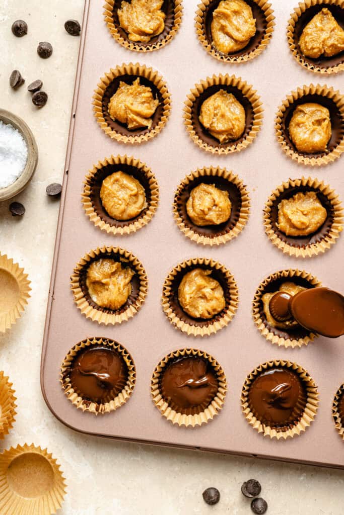 putting chocolate over peanut butter layer