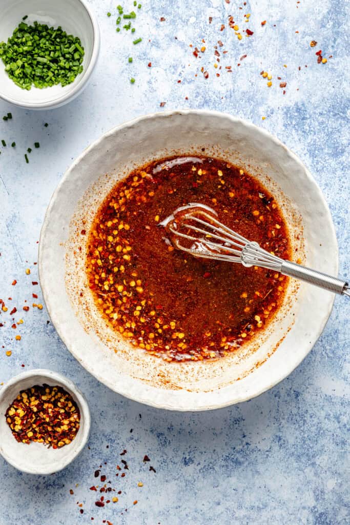 hot honey sauce with whisk in bowl