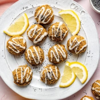 lemon poppy seed energy bites on plate with a drizzle of icing
