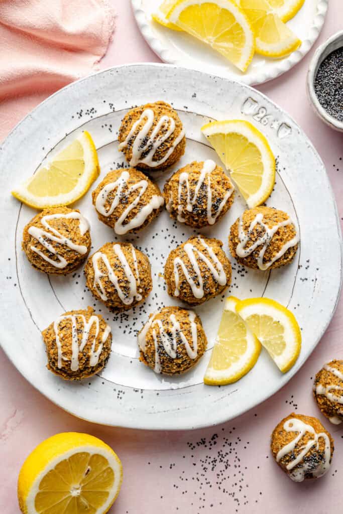 lemon poppy seed energy bites on plate with a drizzle of icing