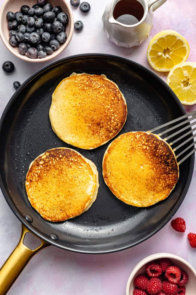 pancakes in pan with spatula