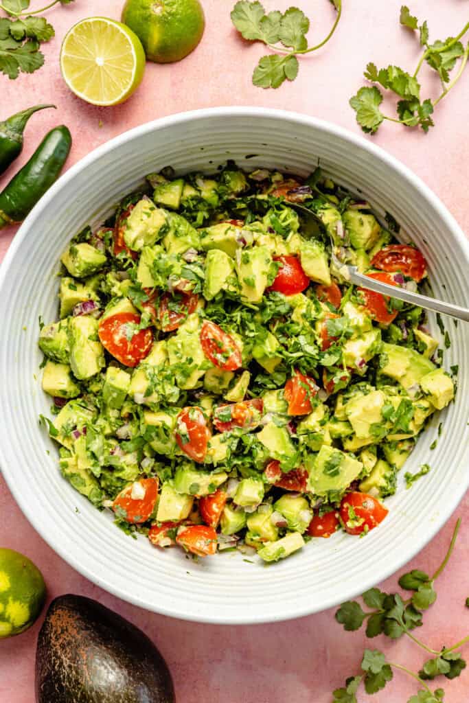 salsa ingredients in mixing bowl with spoon