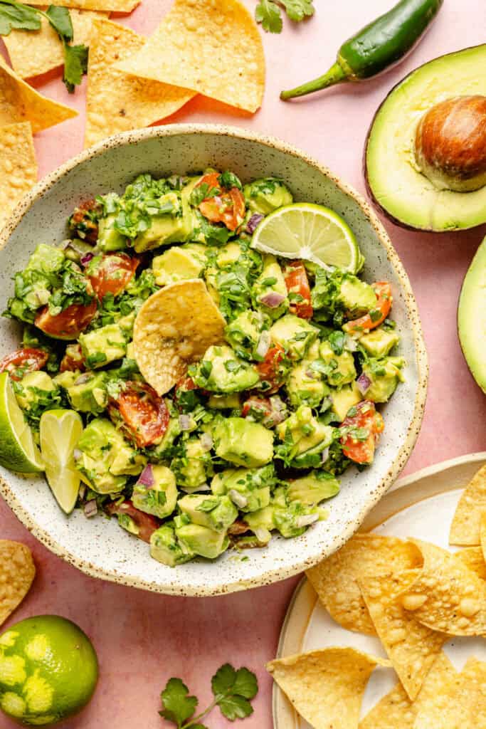 avocado salsa in bowl with chip