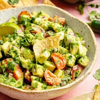 avocado salsa in bowl with chip