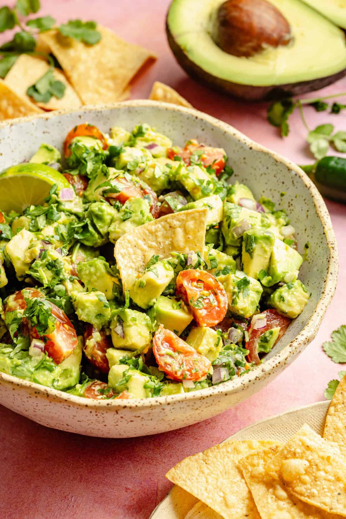 avocado salsa in bowl with chip