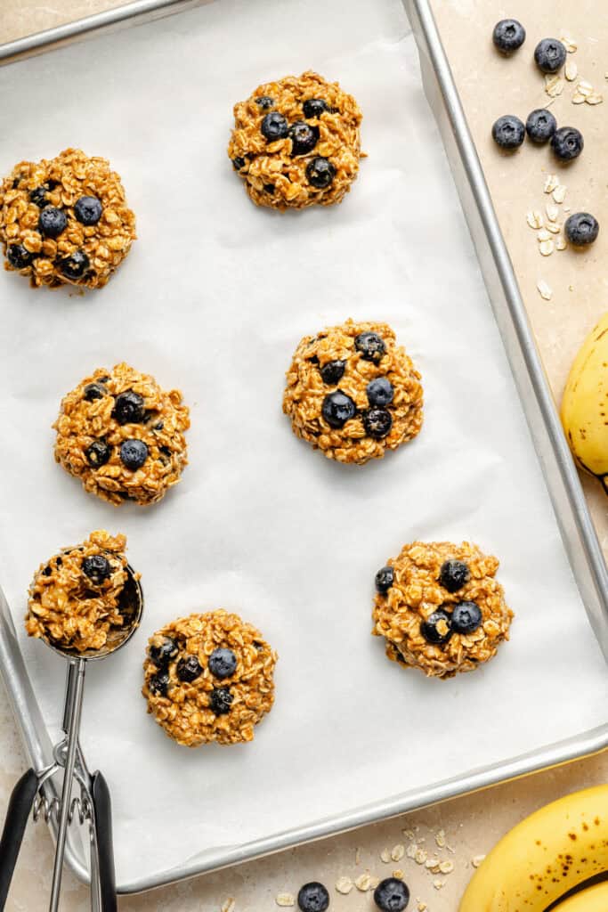 cookies being scooped on sheet pan