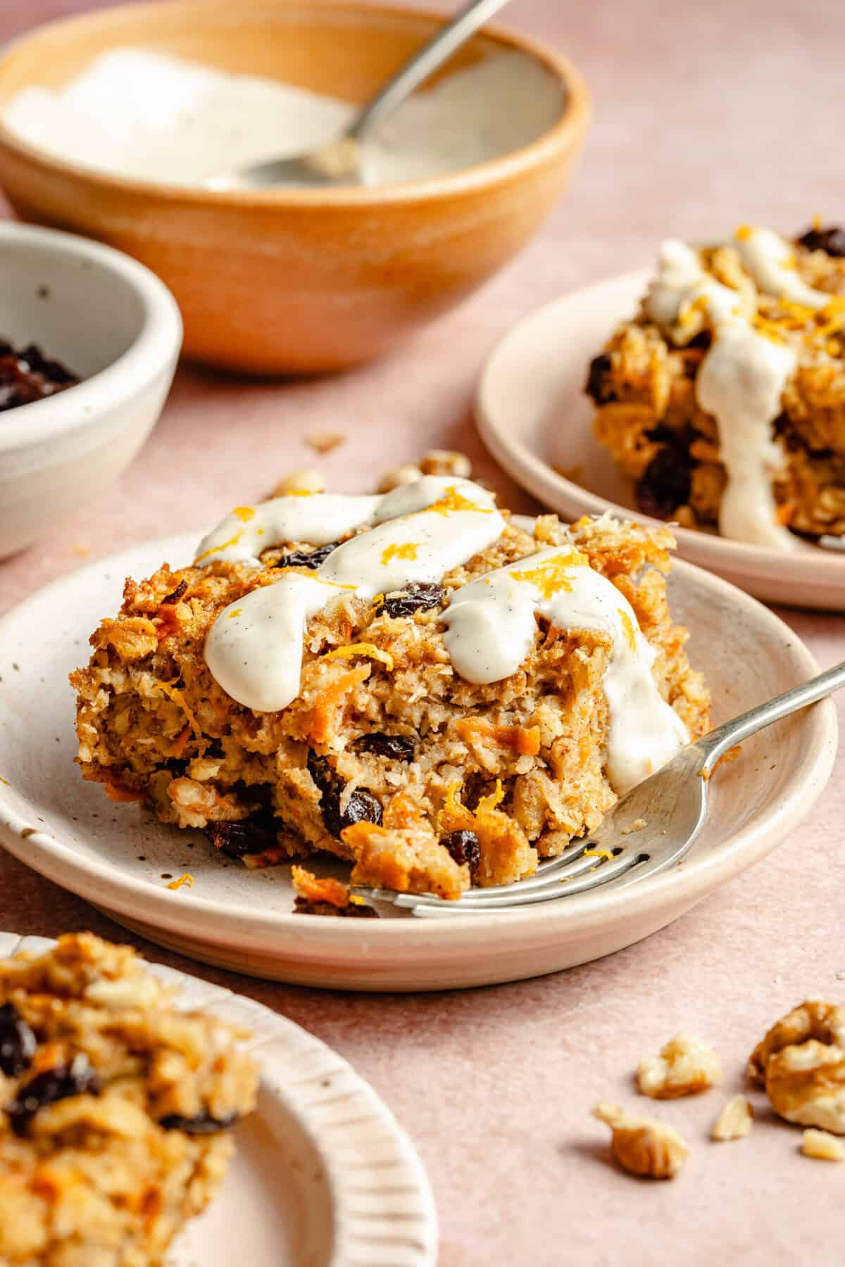 carrot cake baked oatmeal on plate with ceam cheese icing