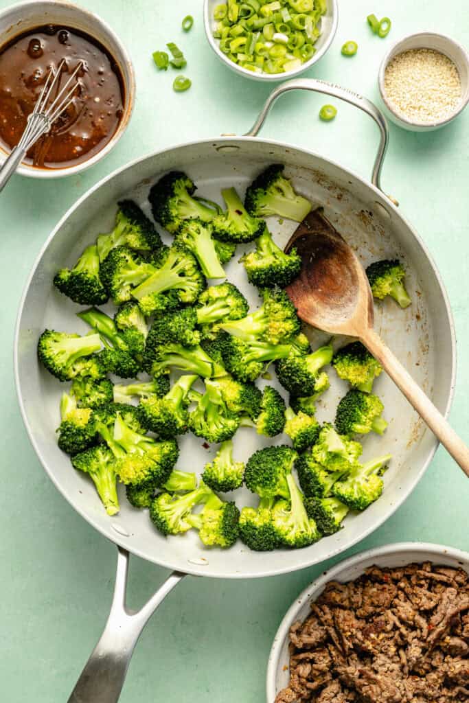 broccoli being steamed in skillet