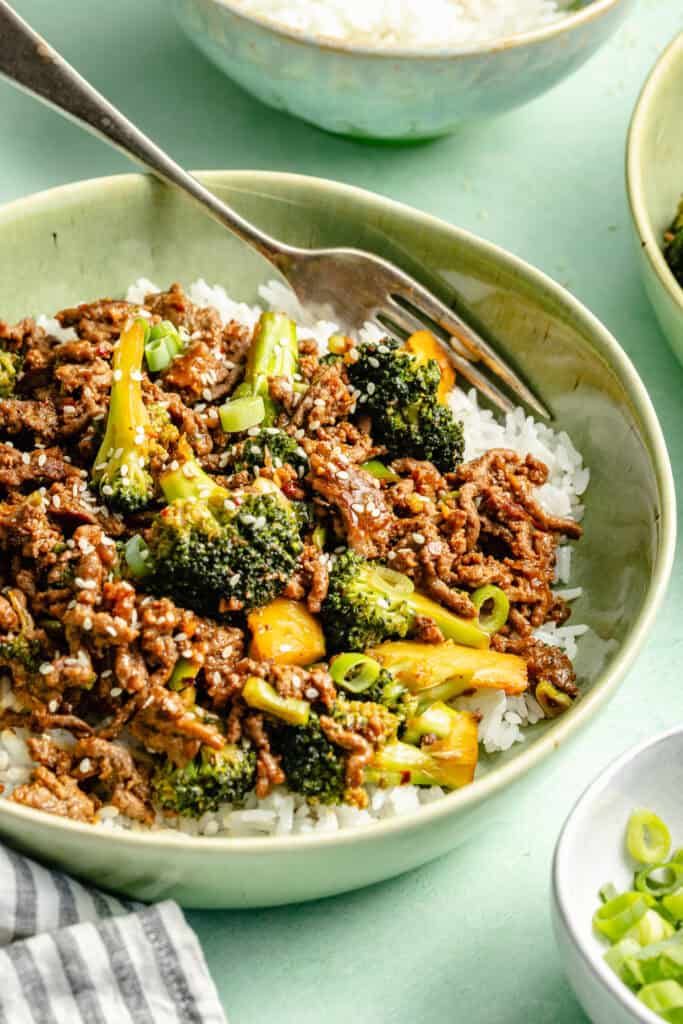 ground beef and brocoli plated over white rice in bowl