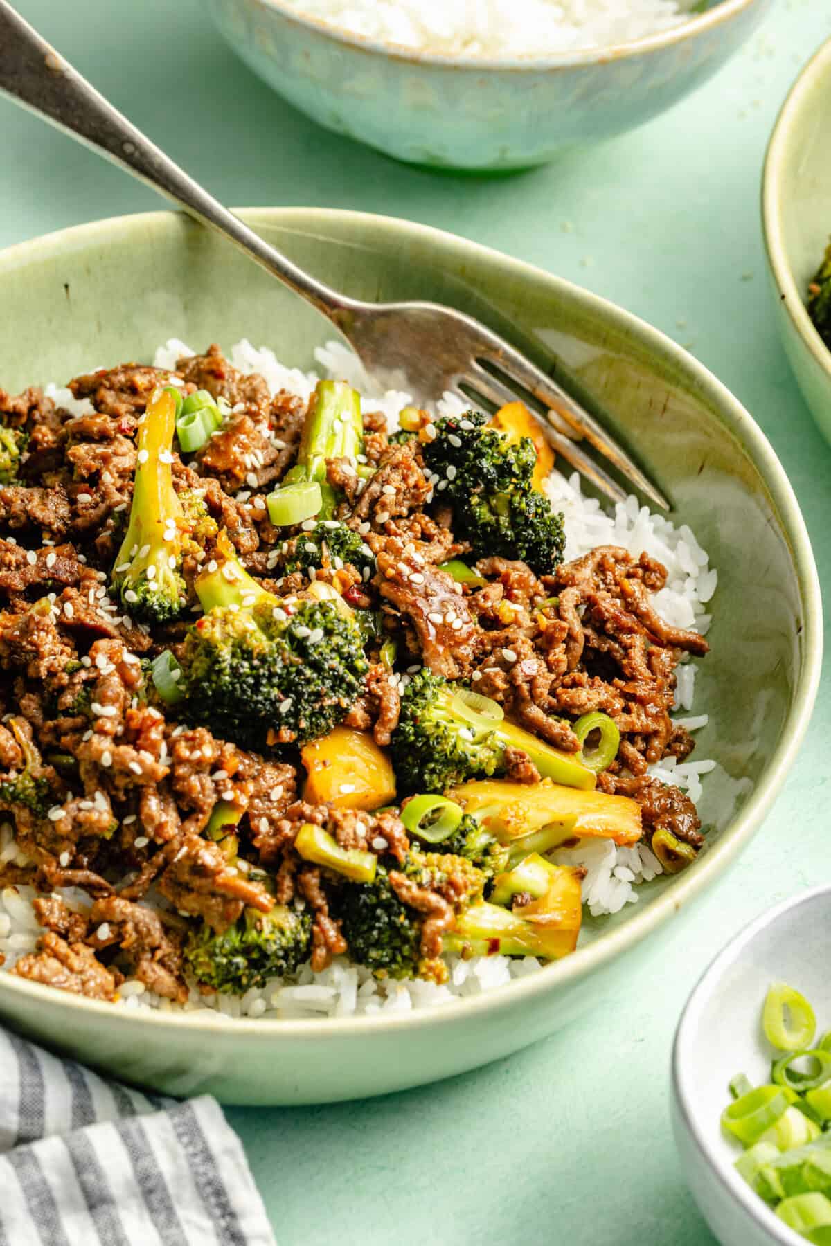 ground beef and brocoli plated over white rice in bowl
