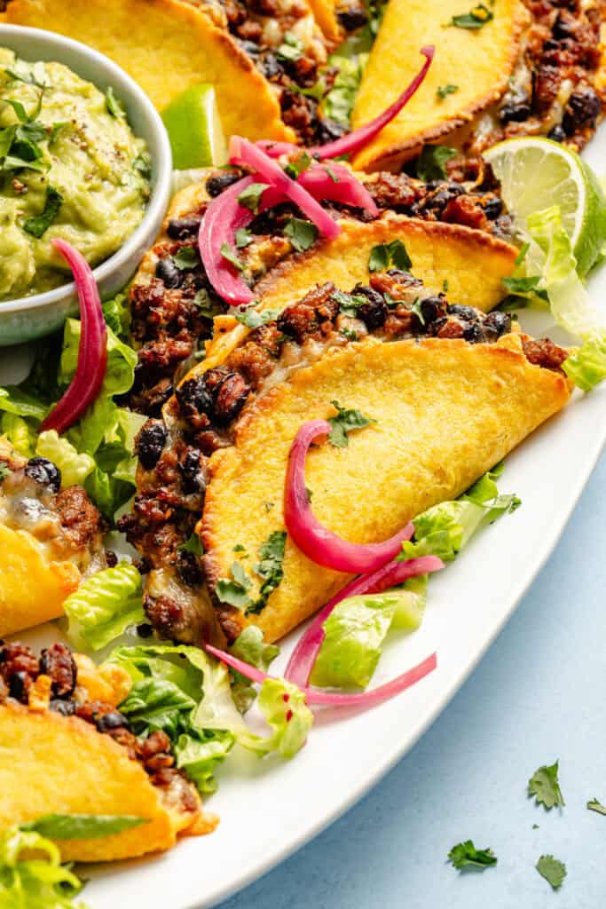 tacos on plate with pickled onions