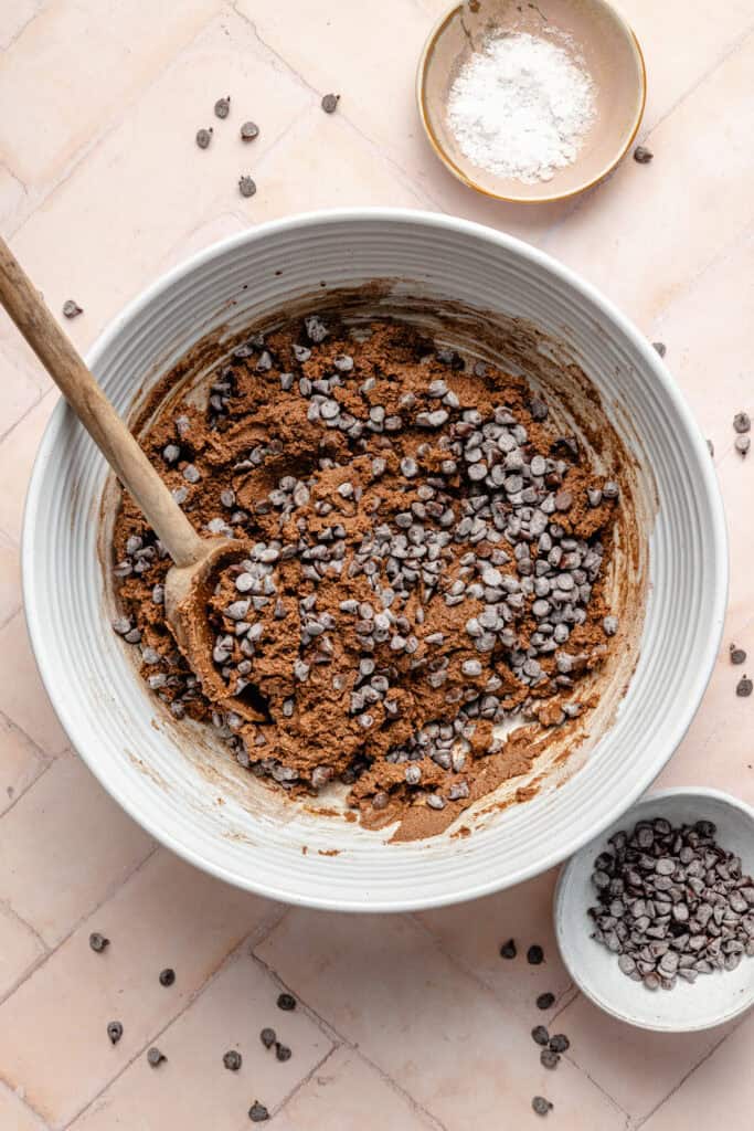 protein bite batter with wooden spoon and chocolate chips