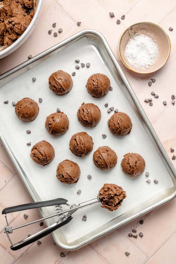 scoops of protein brownie bites on parchment lined sheet pan