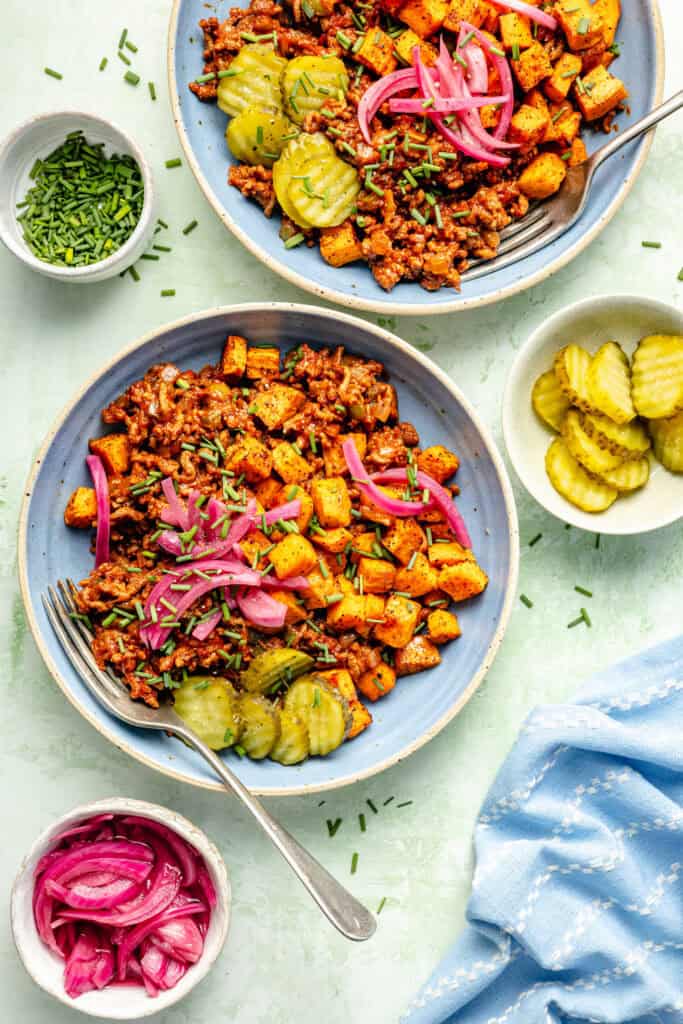 sloppy joe bowls with a small bowl of pickles