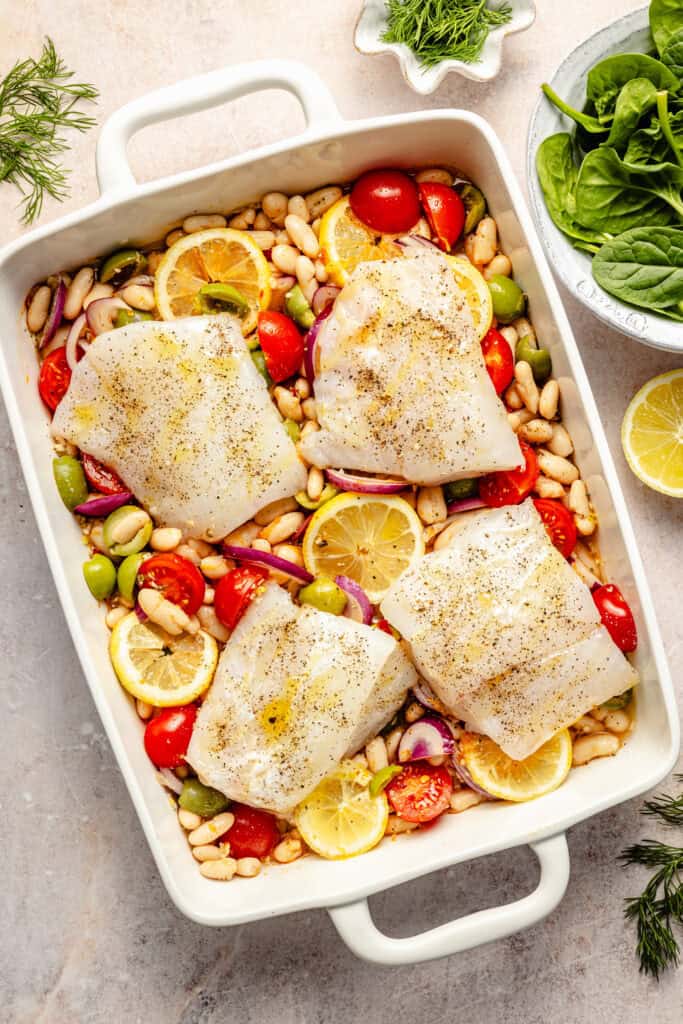 cod over white beans before going into the oven