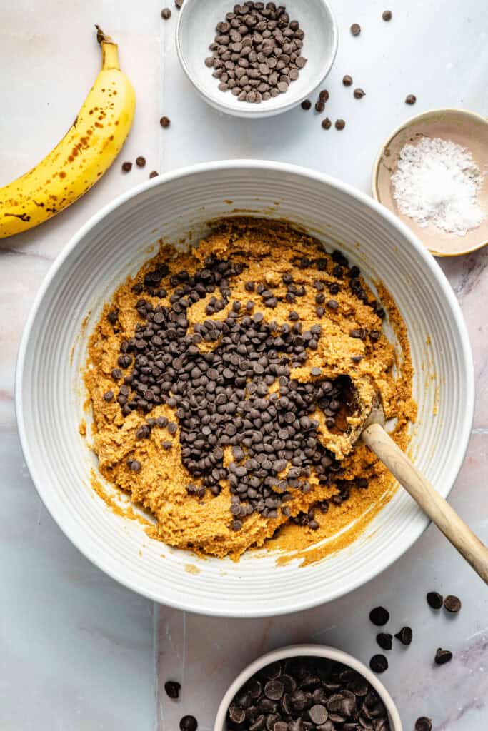 chocolate chips being added to protein ball mixture