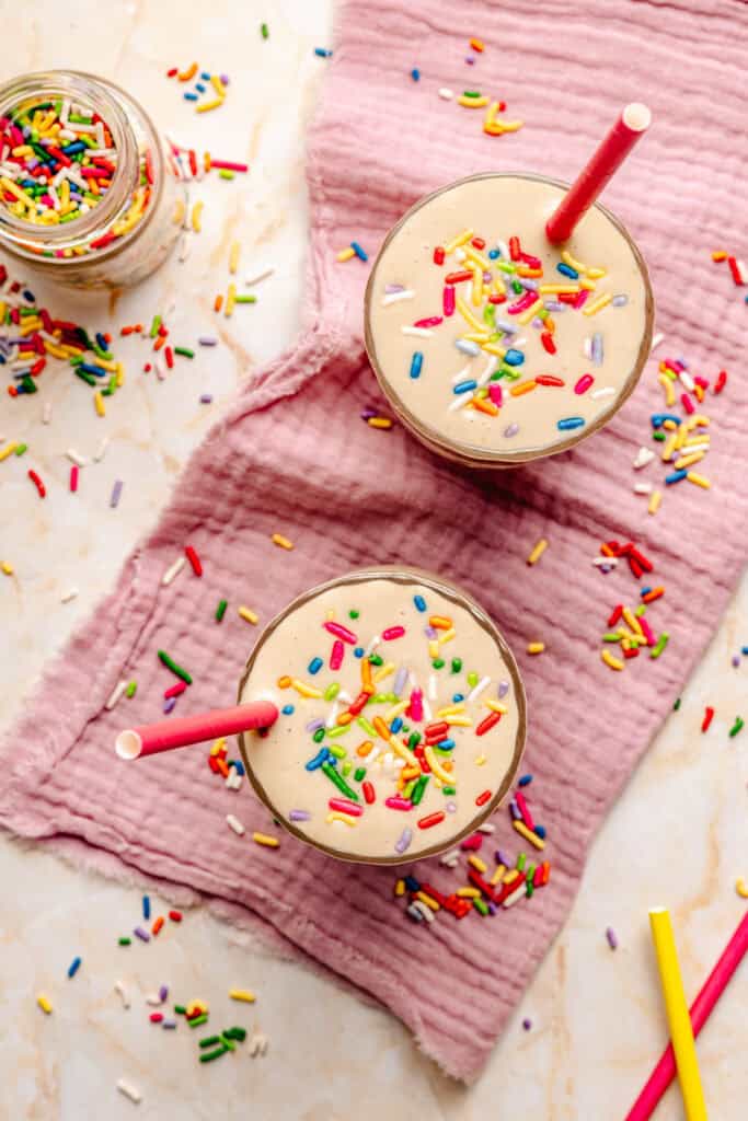 cake batter protein shake with sprinkles in glass