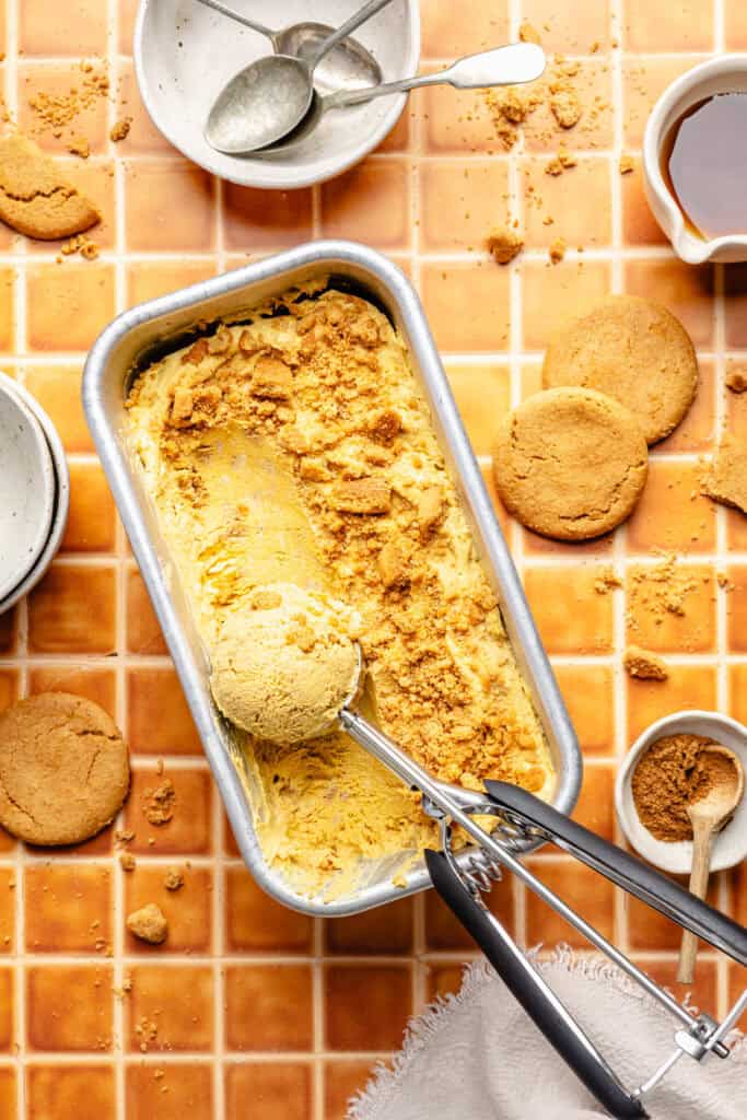 scooped pumpkin pie ice cream in loaf pan with ice cream scoop