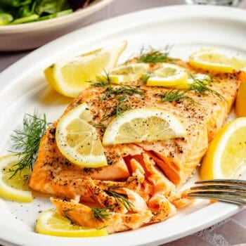 baked salmon on plate with lemon