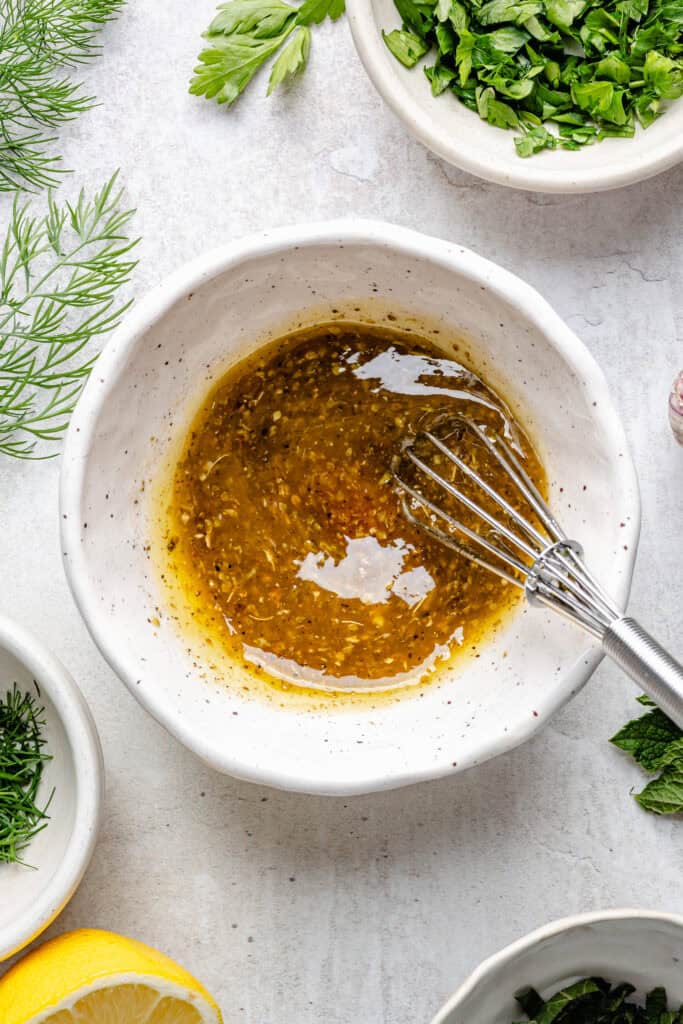 dressing in small mixing bowl with spoon