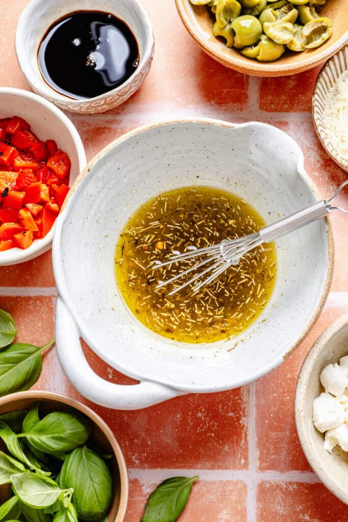 olive oil and spices being whisked together