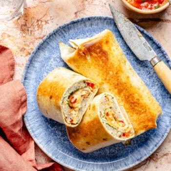 sheet pan breakfast burritos on a plate with a knife