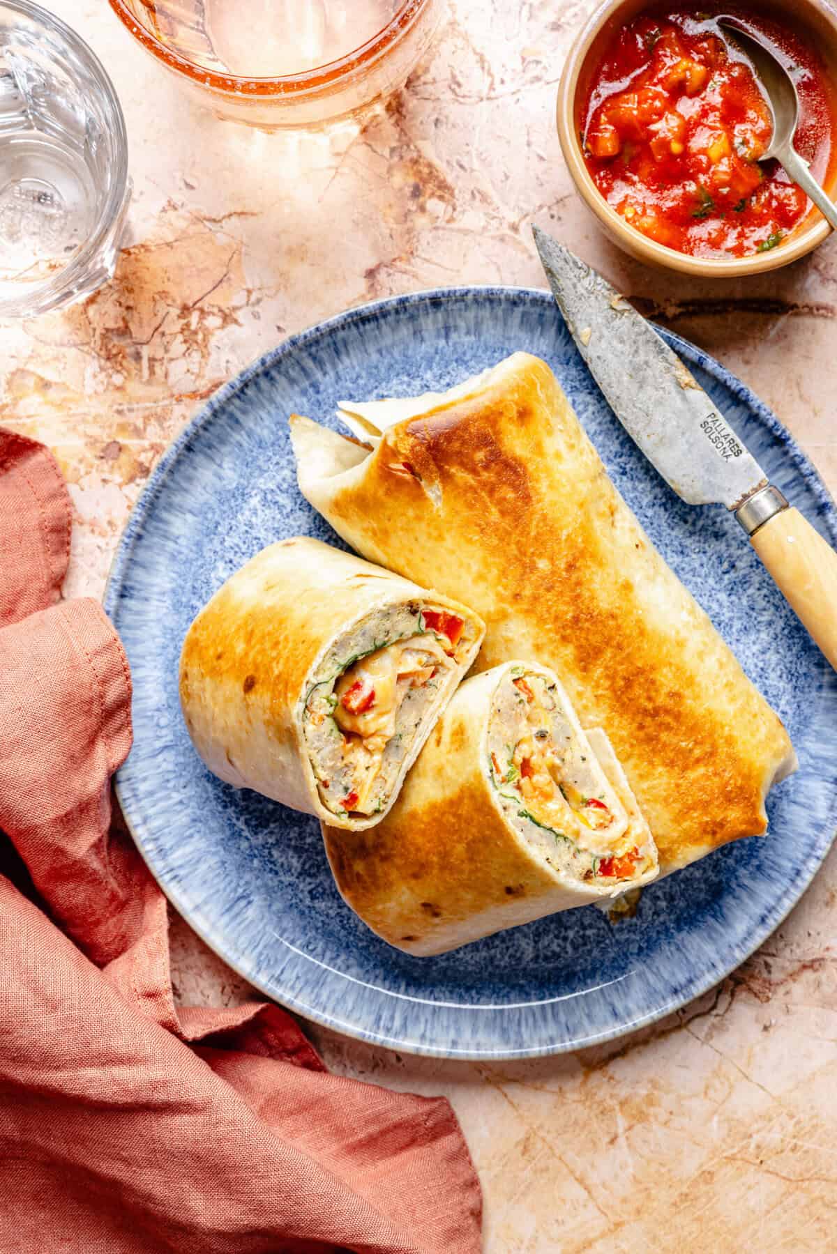 sheet pan breakfast burritos on a plate with a knife