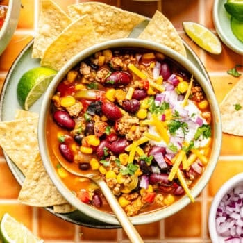 taco soup with toppings in bowl with spoon