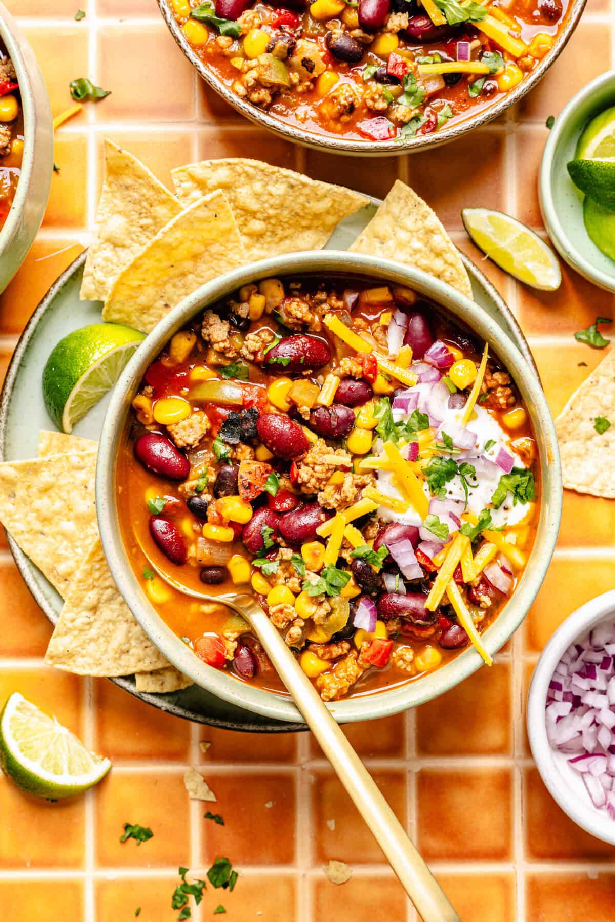 taco soup with toppings in bowl with spoon